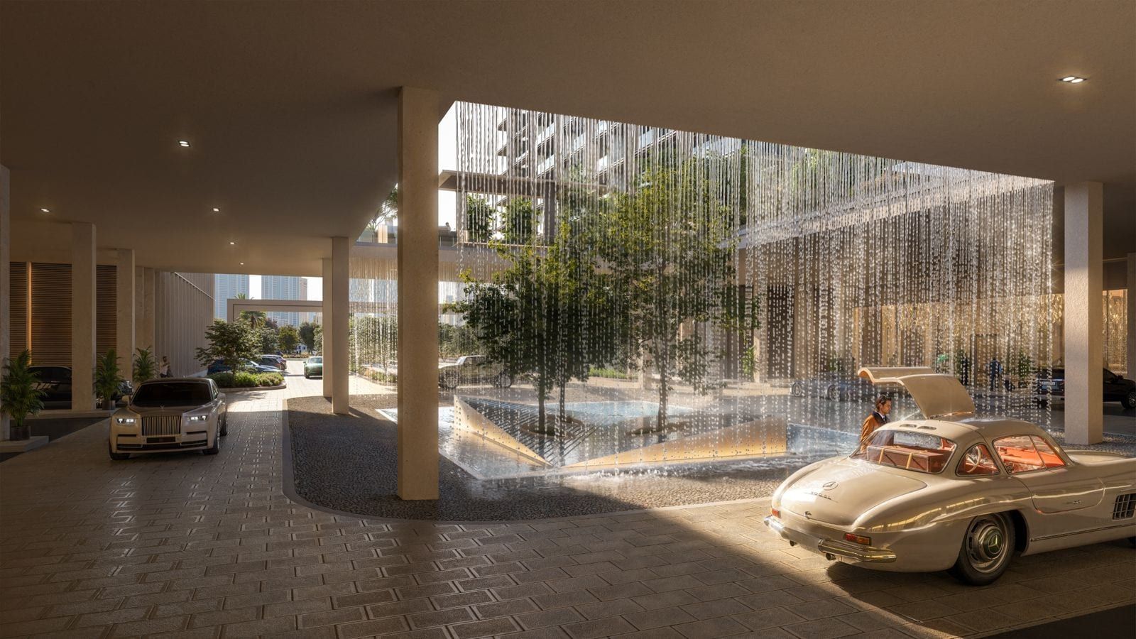 Grand lobby entrance with crystal water feature and luxury vehicles at The Residences DIFC